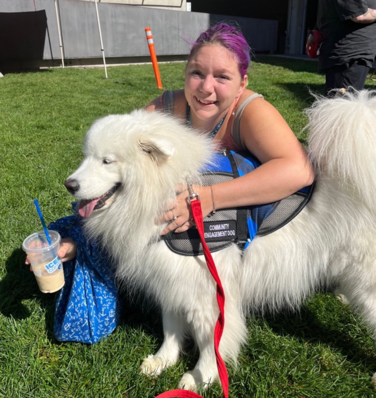 Person hugging Laika Blue at Yale Health event